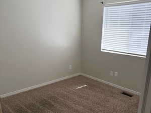 Unfurnished room featuring carpet flooring and baseboards