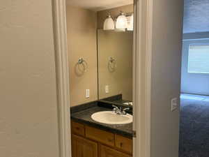 Bathroom featuring tile patterned flooring and vanity
