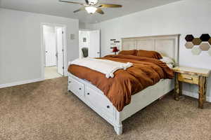Bedroom featuring baseboards, carpet flooring, and ceiling fan
