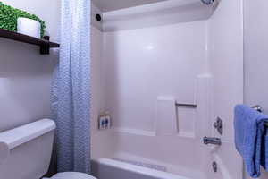 Bathroom featuring toilet and tub / shower combination