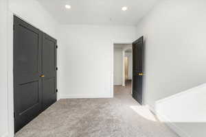 Unfurnished bedroom with baseboards, carpet flooring, and recessed lighting