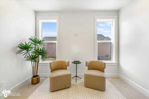 Living area with baseboards and visible vents