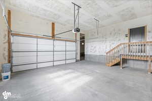 Garage featuring a garage door opener