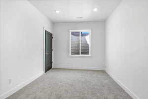 Unfurnished room featuring recessed lighting, baseboards, visible vents, and light colored carpet