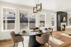 Dining room featuring visible vents, light wood finished floors, baseboards, and a notable chandelier