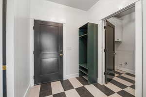 Interior space with baseboards and tile patterned floors