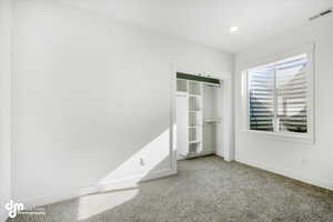 Unfurnished bedroom featuring recessed lighting, carpet, visible vents, a closet, and baseboards