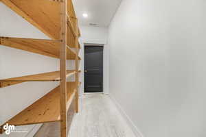 Hall with visible vents and baseboards