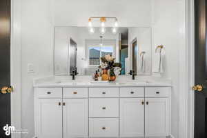 Full bath featuring a sink and double vanity