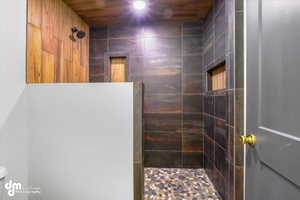 Full bathroom featuring a tile shower