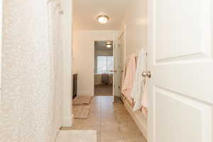 Full bath featuring baseboards, tile patterned floors, vanity, and ensuite bathroom