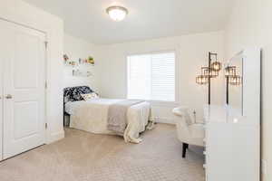 Carpeted bedroom with baseboards