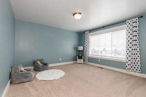 Unfurnished room featuring visible vents, baseboards, and carpet
