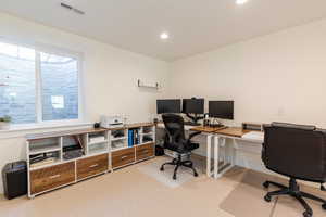 Carpeted home office featuring visible vents and recessed lighting