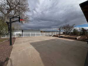View of sport court featuring community basketball court and fence