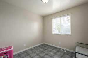 Unfurnished bedroom with visible vents and baseboards