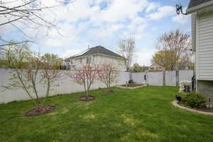 View of yard featuring a fenced backyard and a vegetable garden