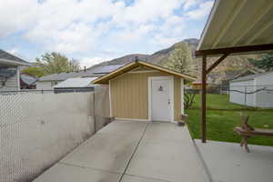 View of shed featuring a fenced backyard and a mountain view