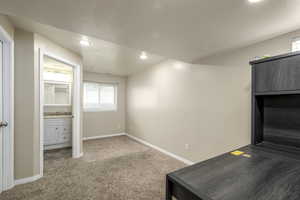 Interior space featuring recessed lighting, carpet floors, baseboards, and a sink