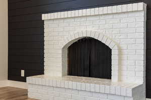 Room details featuring arched walkways and wood finished floors