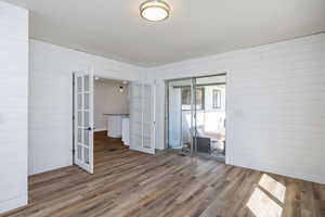 Empty room featuring french doors and wood finished floors
