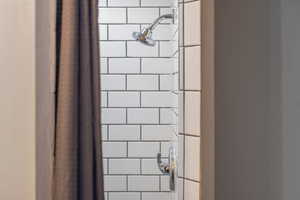 Interior details featuring a tile shower