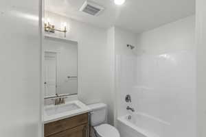 Full bathroom featuring shower / washtub combination, toilet, and vanity