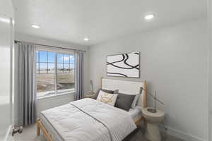 Carpeted bedroom with large windows, mountain views, and recessed lighting