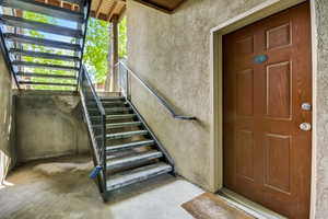 Doorway to property featuring stucco siding