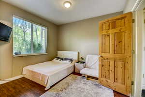 Bedroom featuring baseboards and dark wood finished floors