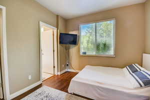 Bedroom with baseboards and wood finished floors