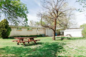 View of yard featuring an outbuilding and central air condition unit