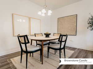 Dining space featuring baseboards, wood finished floors, and a notable chandelier
