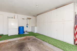 Garage featuring freestanding refrigerator
