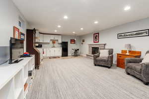 Living room featuring recessed lighting, a fireplace, and baseboards