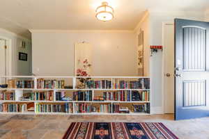Interior space featuring stone finish floor and ornamental molding