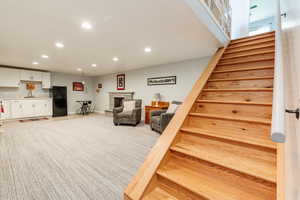 Stairs with a fireplace, baseboards, and recessed lighting