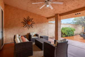 View of patio / terrace with a ceiling fan, visible vents, and fence