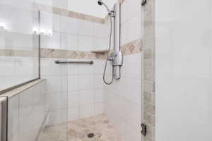 Full bath featuring tiled shower