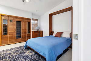 Carpeted bedroom featuring ceiling fan and lofted ceiling