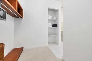 Spacious closet with light tile patterned flooring