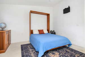 Bedroom featuring baseboards and light colored carpet