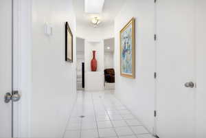 Corridor featuring baseboards and light tile patterned floors