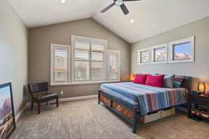 Carpeted bedroom with a ceiling fan, baseboards, recessed lighting, and lofted ceiling