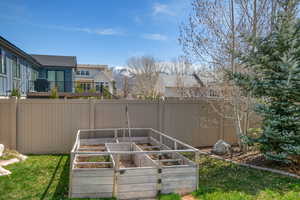 View of yard with a fenced backyard and a vegetable garden