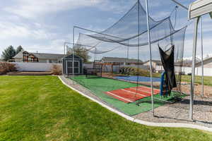 Exterior space featuring a fenced backyard, an outdoor structure, and a shed