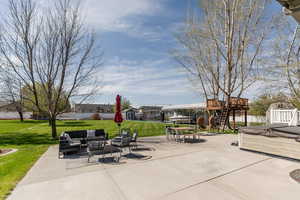 View of patio / terrace featuring stairway, an outdoor living space, a deck, a hot tub, and an outbuilding