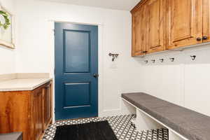 Mudroom with tile patterned floors and baseboards