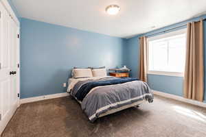 Bedroom with baseboards, carpet flooring, and visible vents