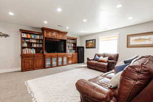 Living area with baseboards, light carpet, and recessed lighting